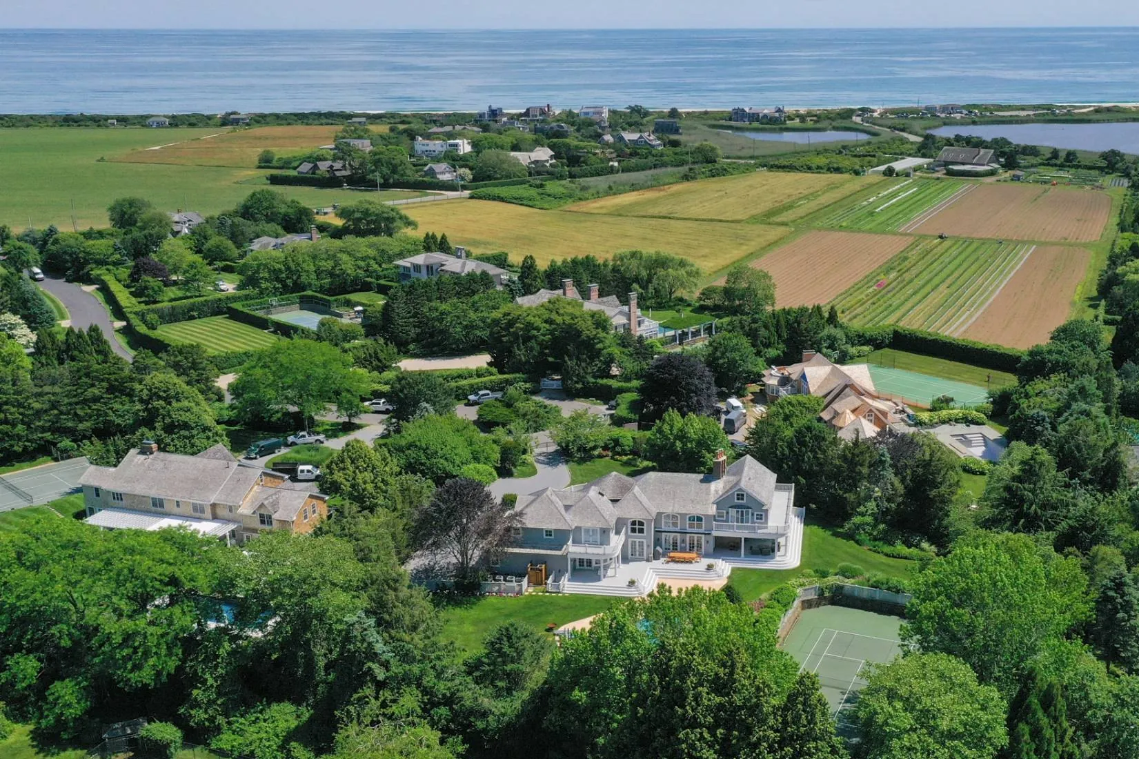 Aerial view over Sagaponack fields to the Atlantic, with 36 Sagg Pond Court in the foreground